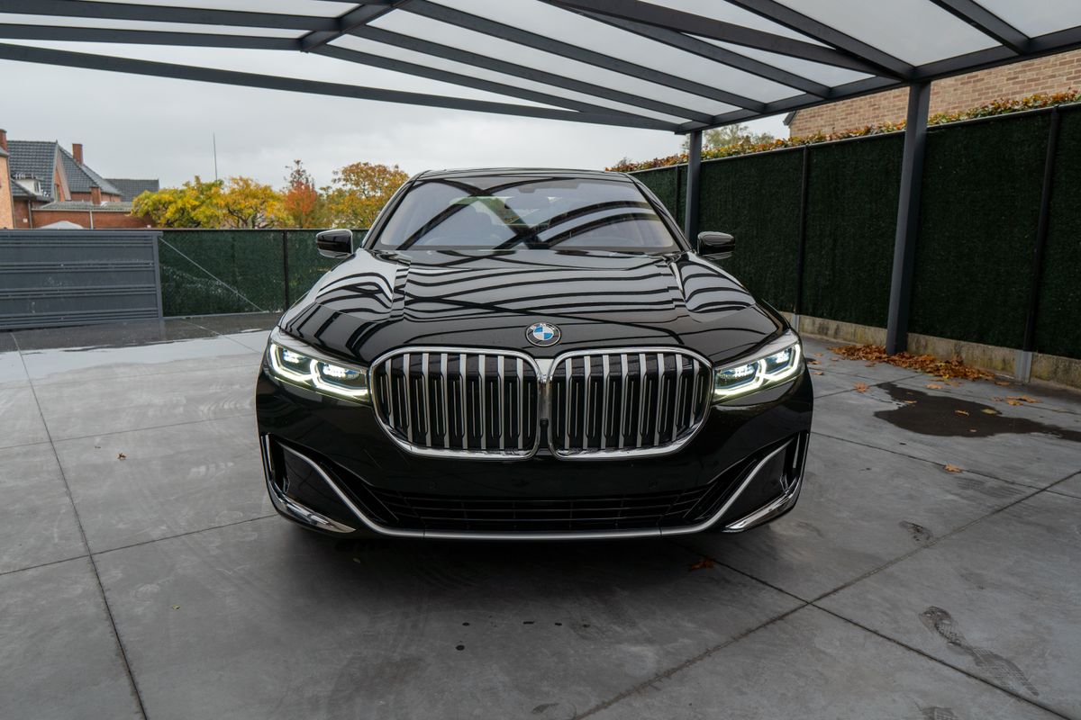 Front view of a shiny black luxury car parked