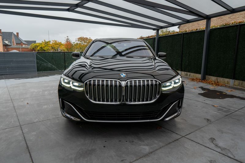 Front view of a shiny black luxury car parked