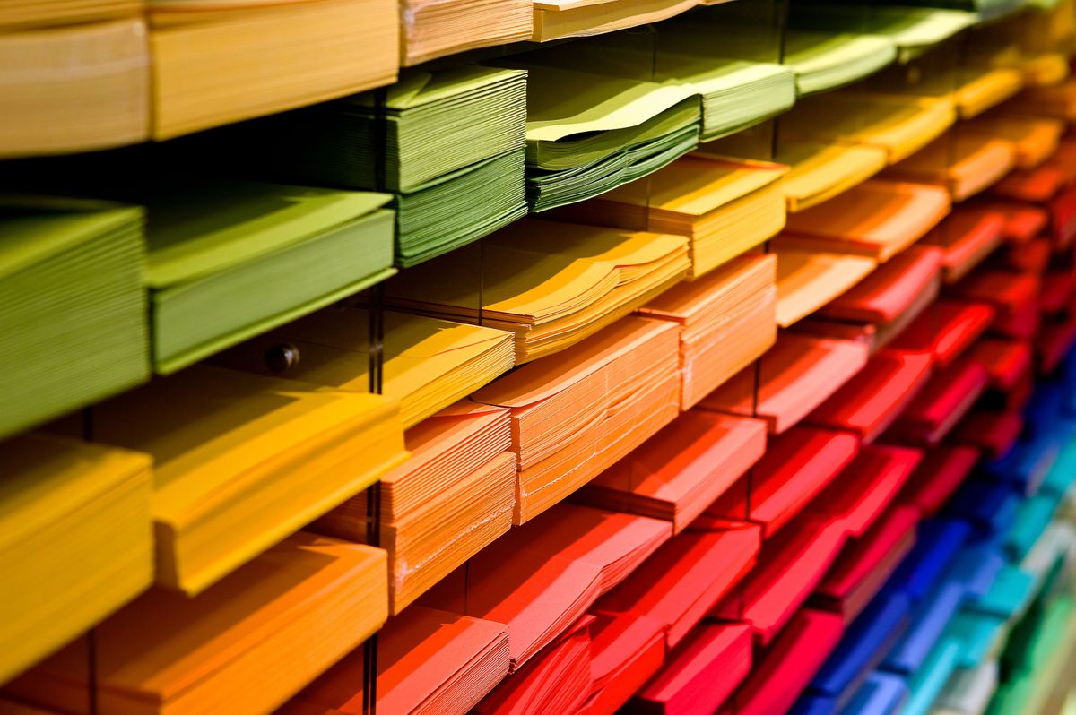 Colorful stacks of paper on shelves