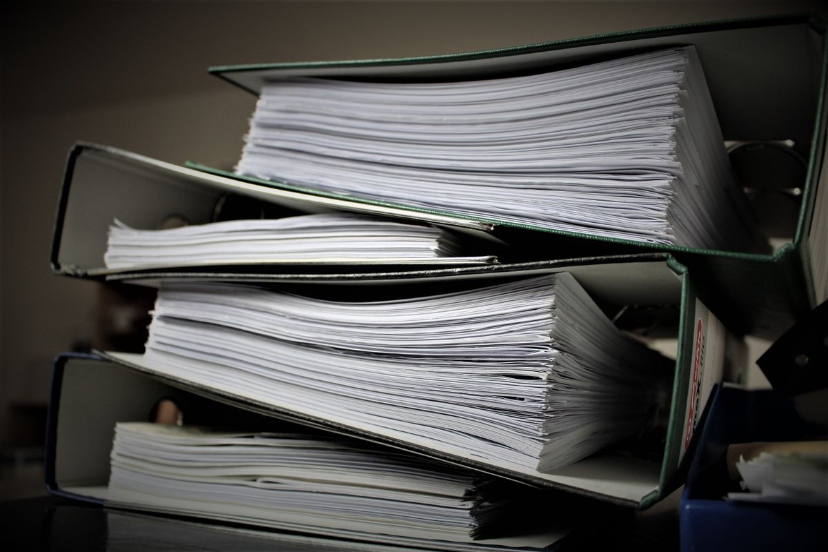 Close-up of stacked binders filled with documents for office or educational use