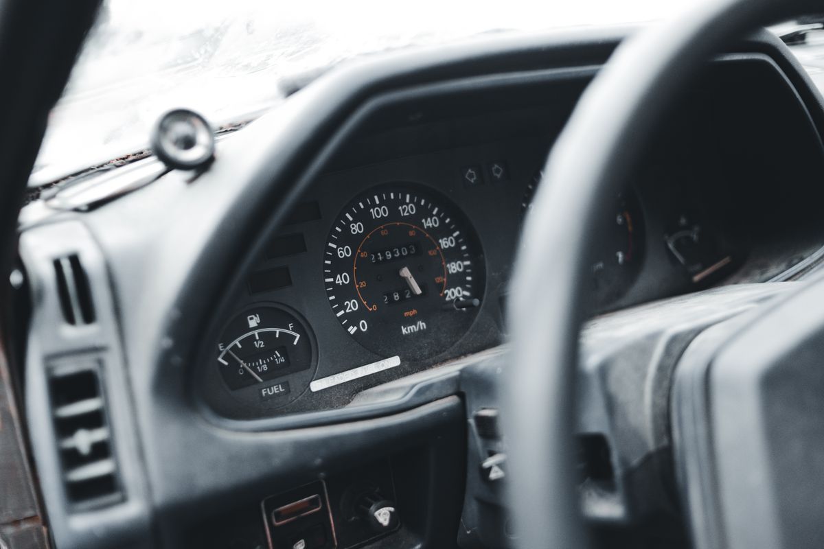 Detailed view of an automobile dashboard focusing on the speedometer and fuel gauge